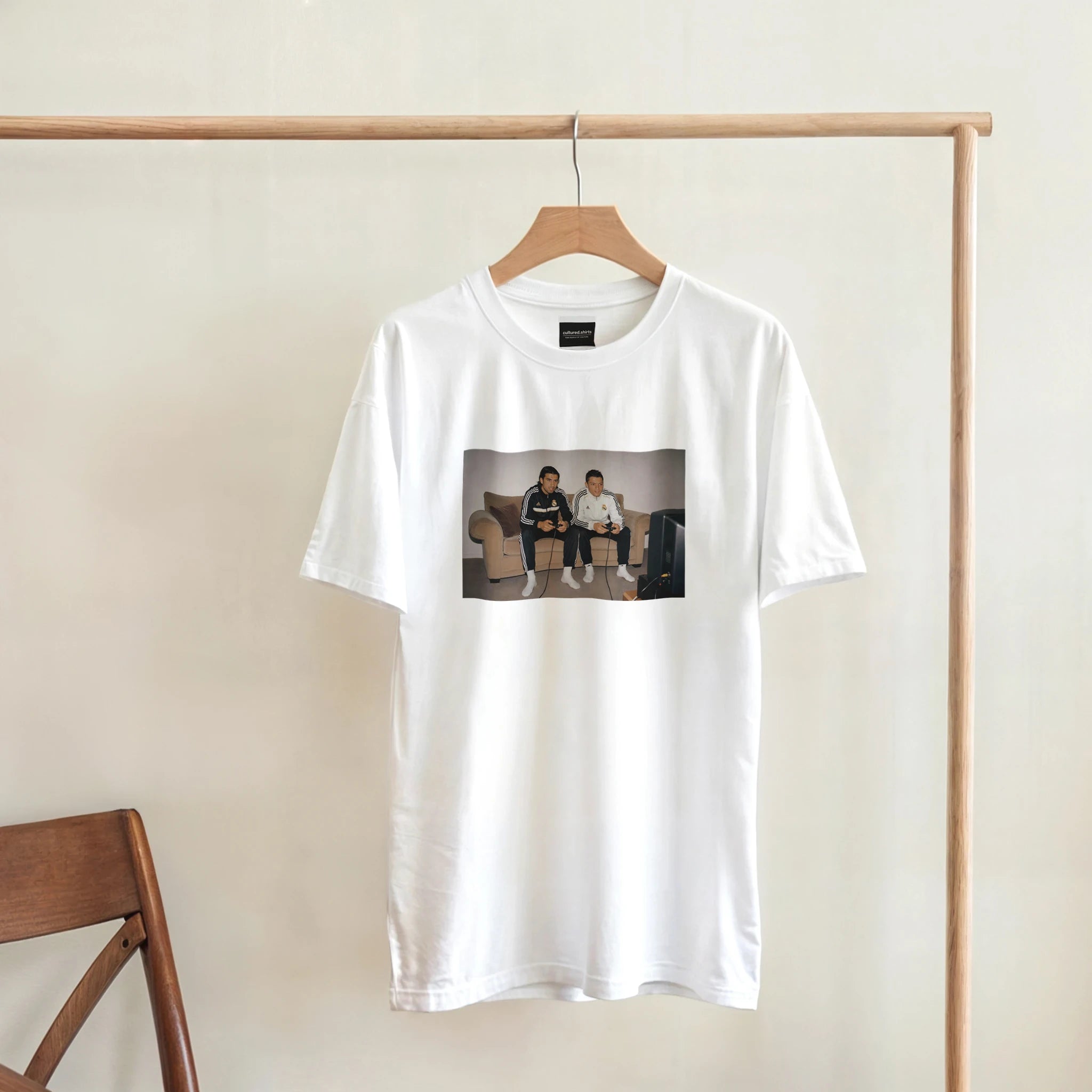 White T-shirt hanging with front rectangular photo graphic of two men