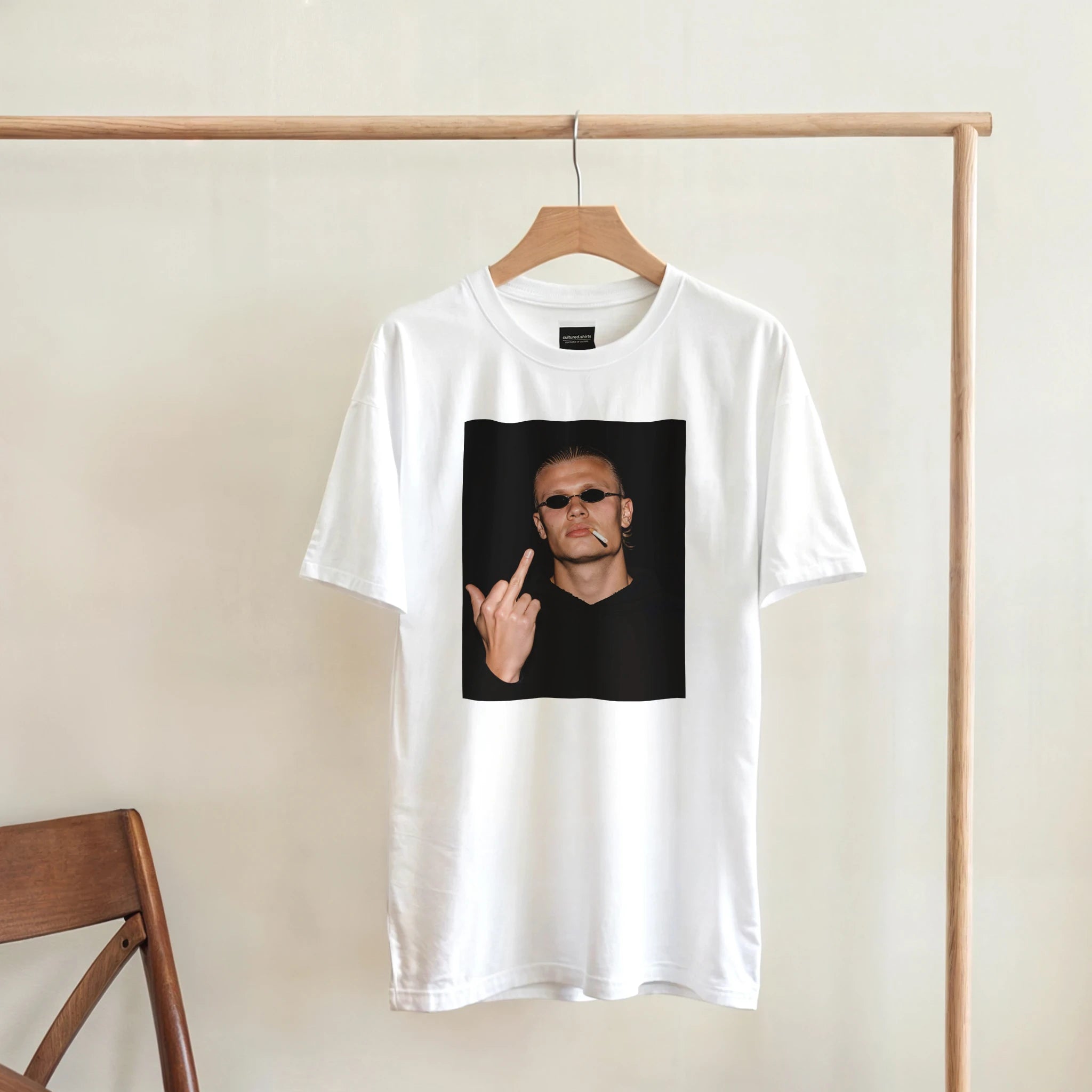 White crewneck T-shirt with square portrait graphic and sunglasses design, hanging