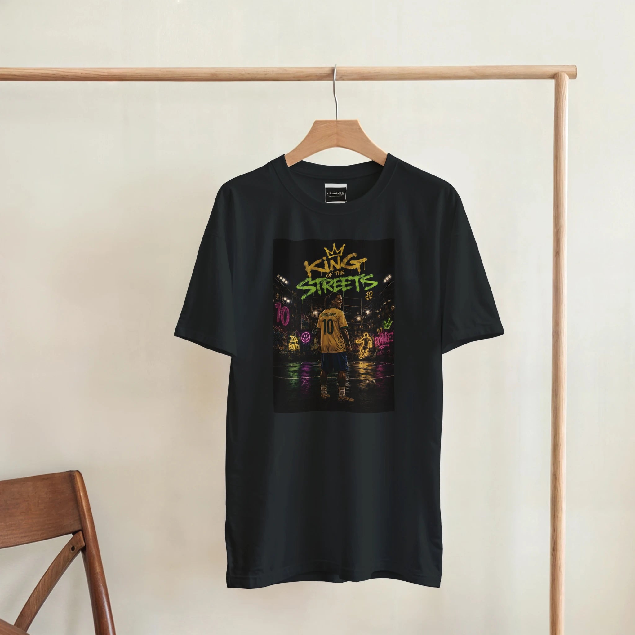 Black T-shirt hanging on a rack with centered square street football graphic