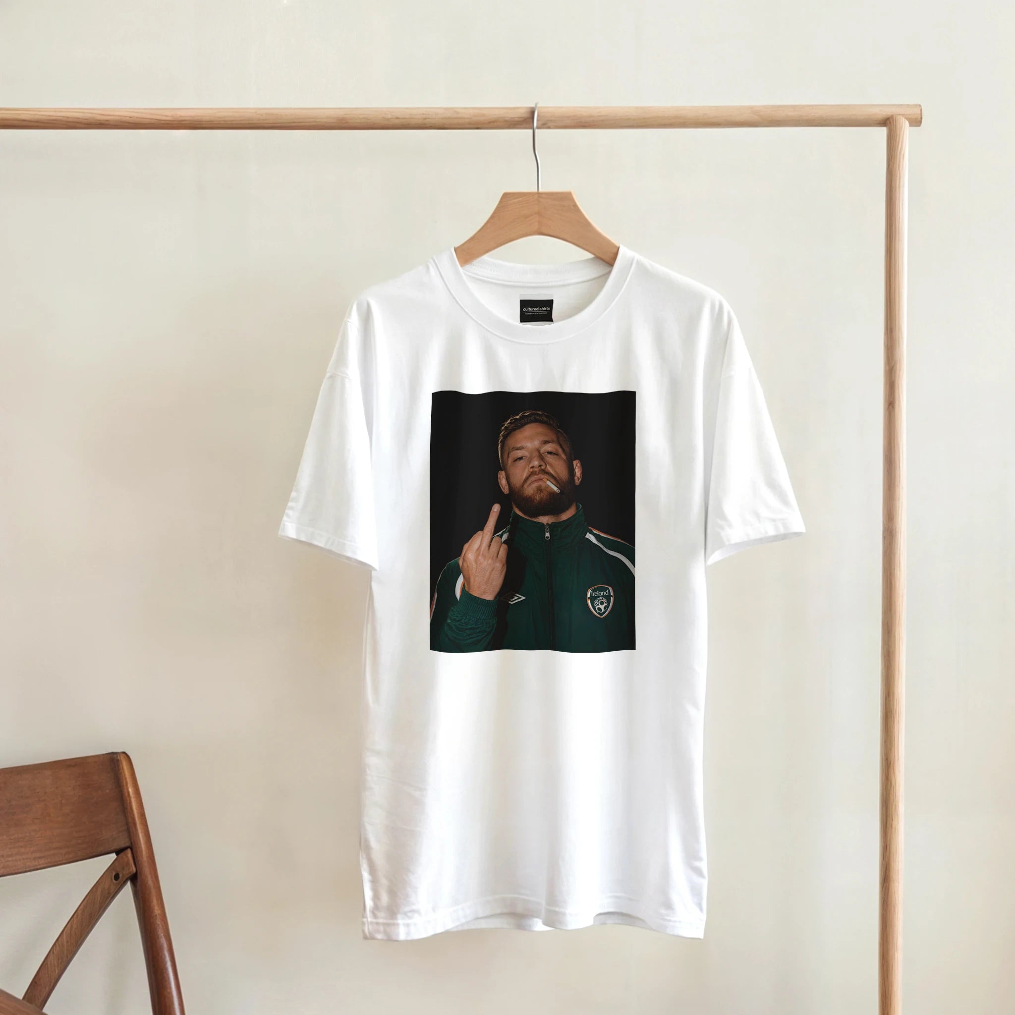 White crewneck T-shirt with centered portrait graphic of Conor McGregor in a green tracksuit