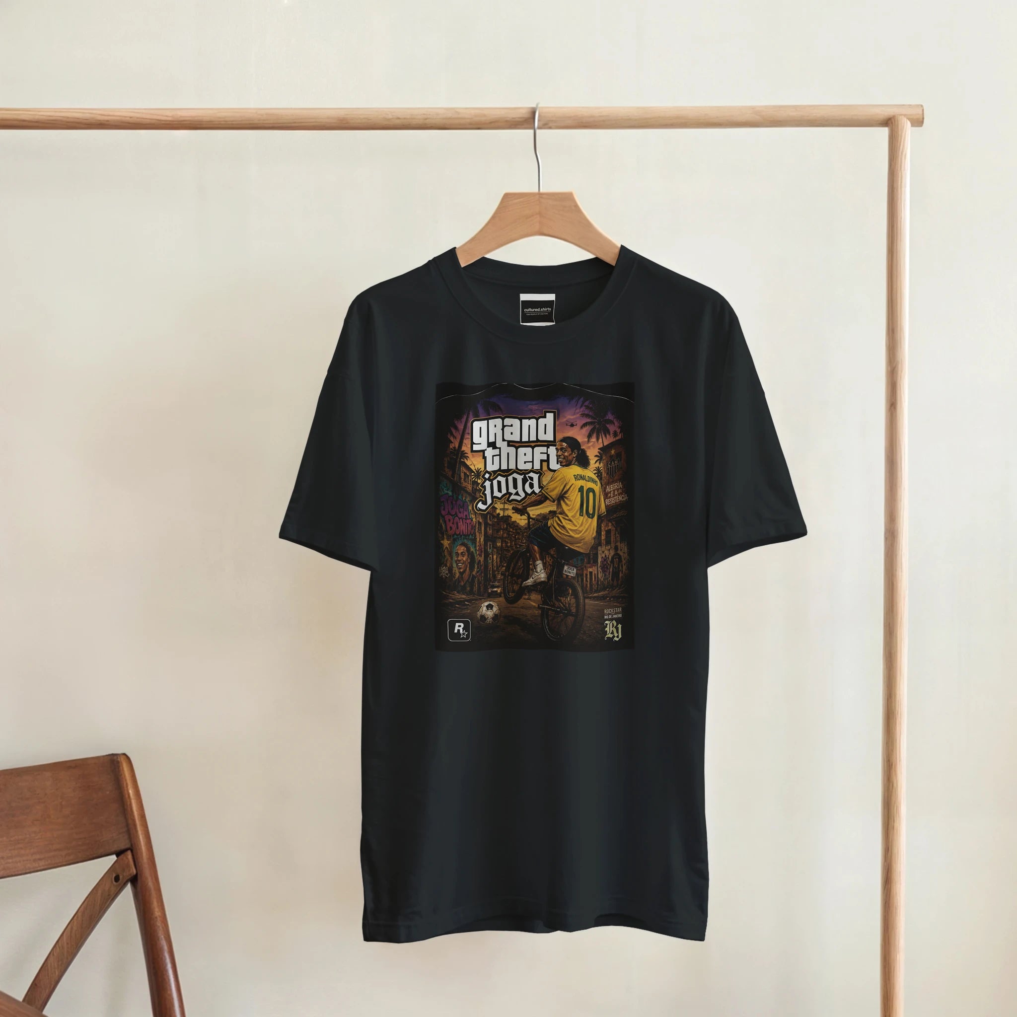 Black crew-neck T-shirt hanging with Grand Theft Joga graphic on chest.