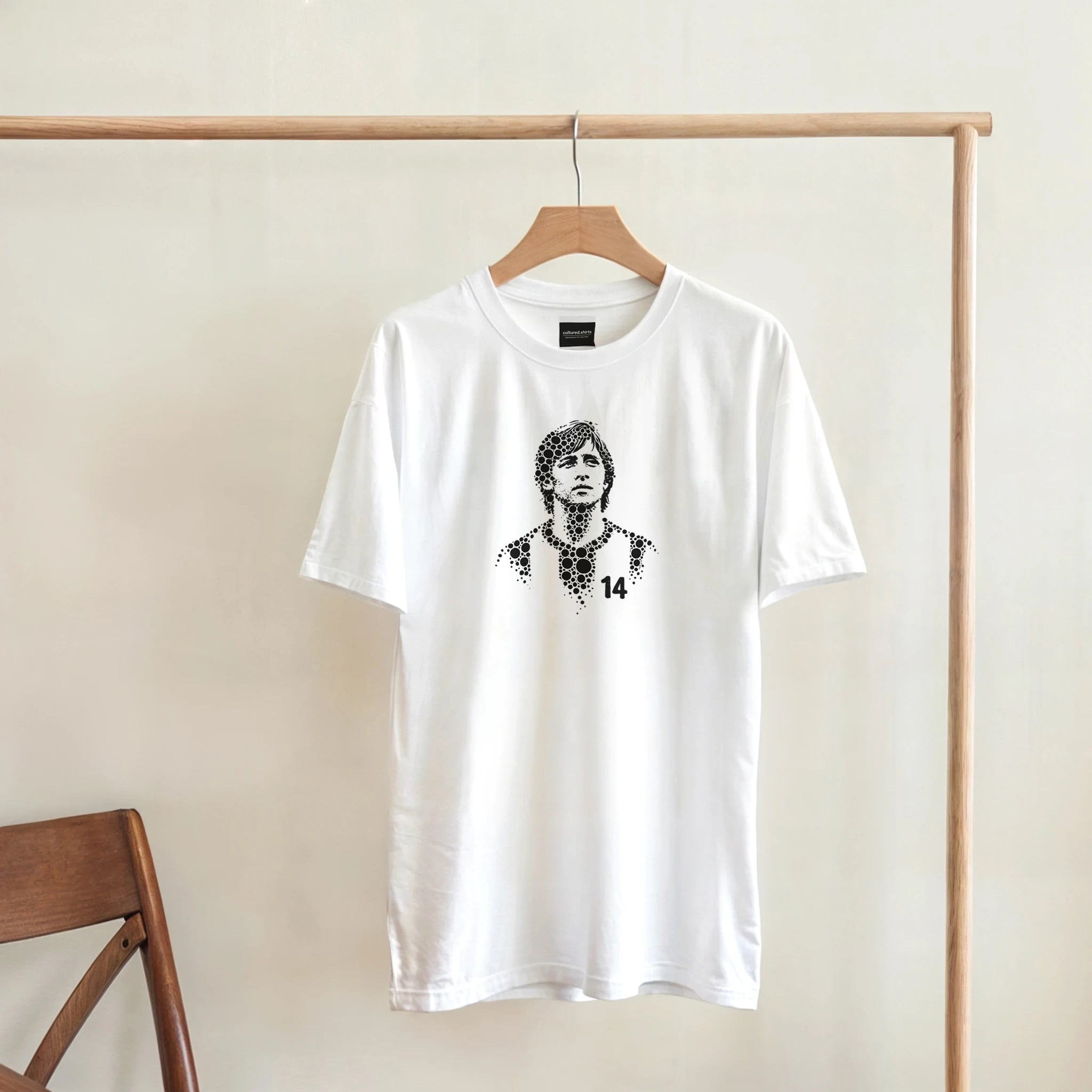 Johan Cruyff T-shirt on hanger, white with black portrait and number 14 graphic